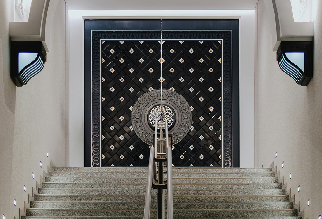 About Carousel - a staircase leading up to a doorway with a clock on it